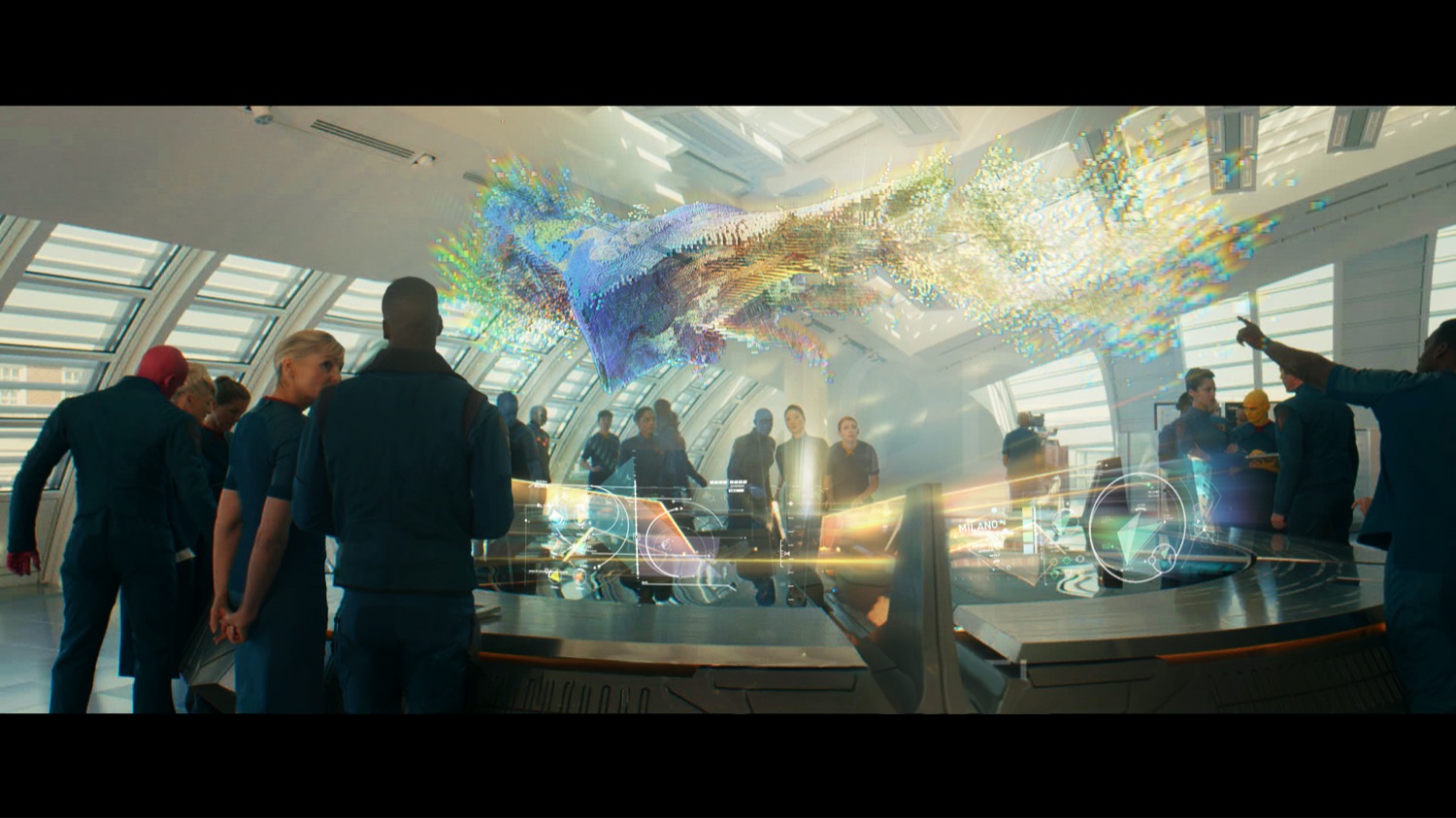 Film VFX shot — a crowd watching a holographic form unfold above a briefing table