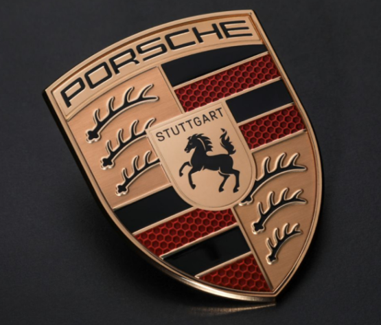 The Porsche crest, the source for the shield shape and gold finish in the collab mark.